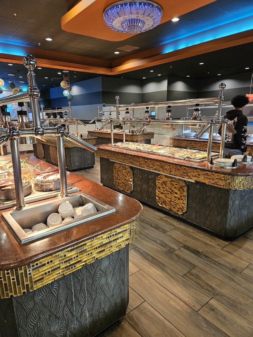 Buffet trays with assorted dishes and serving spoons.