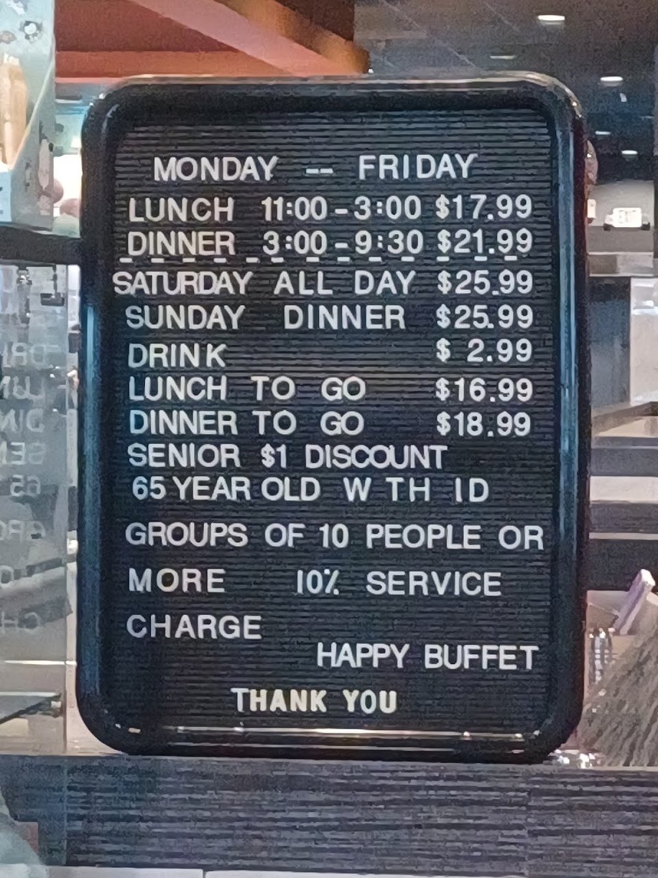 Printed menu beside buffet-style dishes.